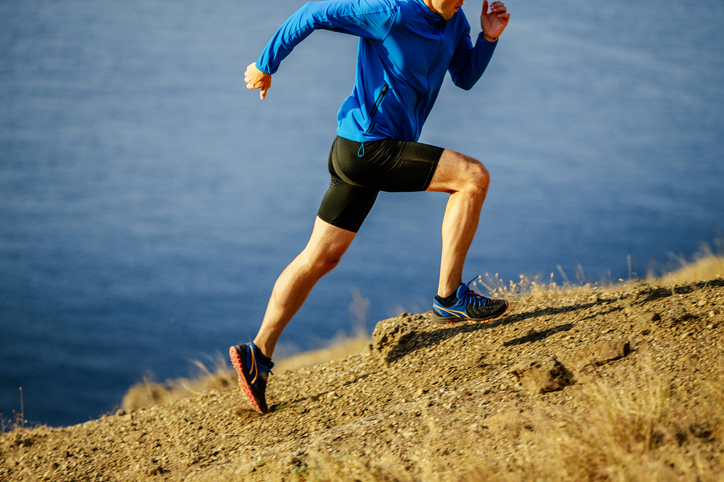 A man runs on a steep trail. Many athletes -- even elites -- settle for good enough when intentionally disrupting your own training can create breakthrough performances or at least marginal gains.