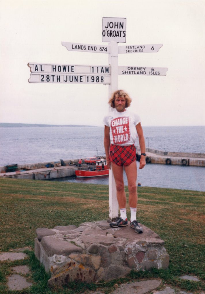 Al Howie posing for a traditional route shot of the End-to-End Run, wearing red tartan running shorts